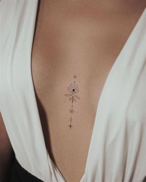 small tattoos between breast|40 Gorgeous Tattoos Between Boobs